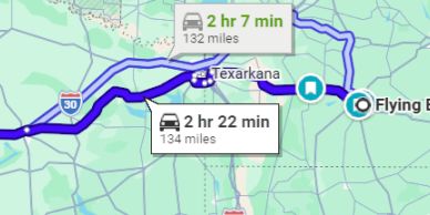 Map showing two driving routes between Flying B and Texarkana with different travel times and distances.