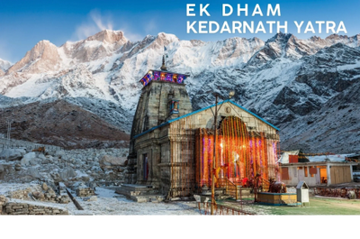 Kedarnath temple illuminated against snowy Himalayan mountains.