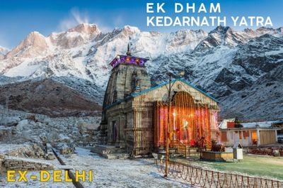 Kedarnath temple illuminated at dawn with snowy mountains in the background.