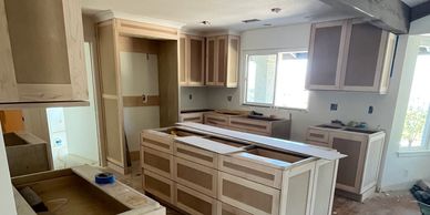 Kitchen under renovation with new cabinets installed.