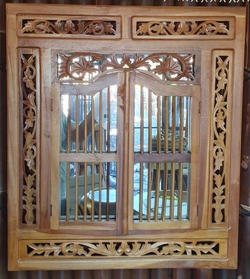 Ornate wooden window with intricate carvings.