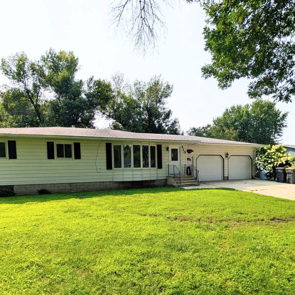 Single-story house with a large front yard and garage.