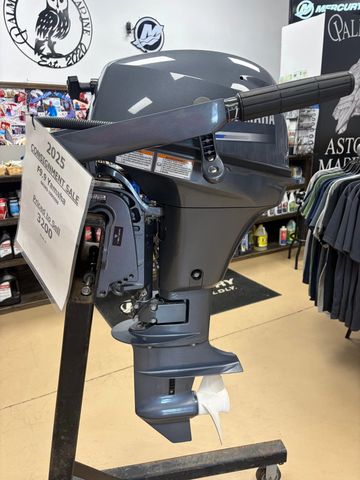 A 2023 Mercury outboard motor on display with a sale tag.