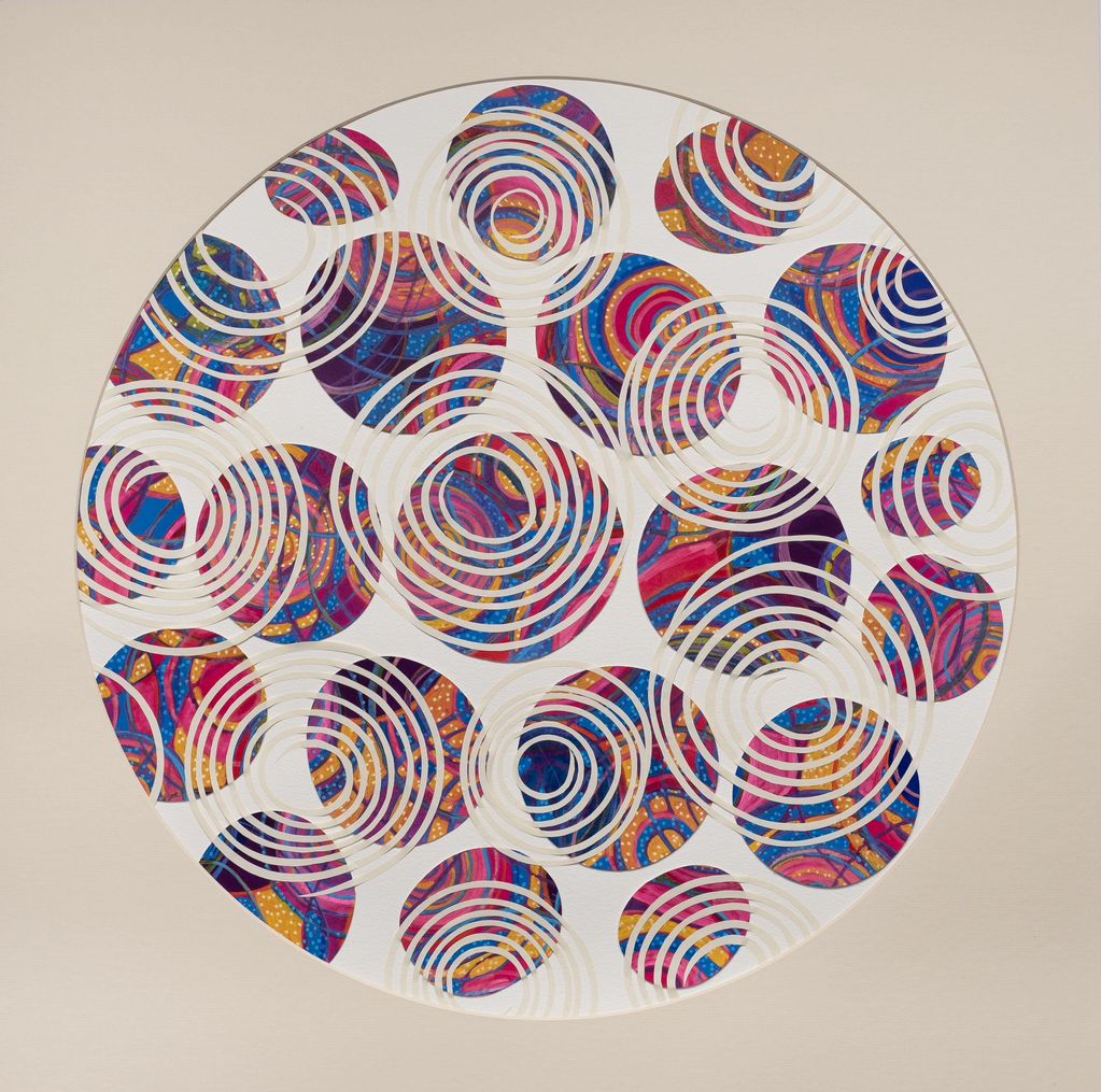 Abstract circular pattern with vibrant colors and concentric white rings.