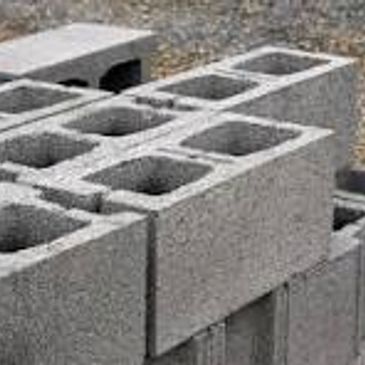 Gray concrete cinder blocks stacked.