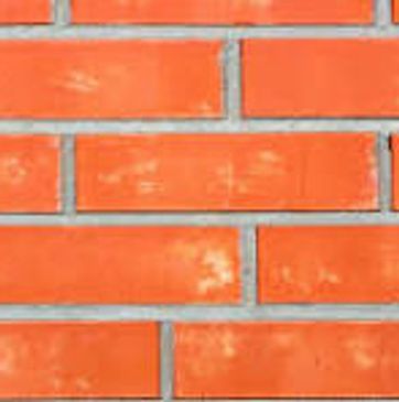 Close-up of orange brick wall with mortar.