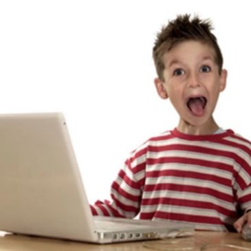 Surprised boy looking at laptop screen.
