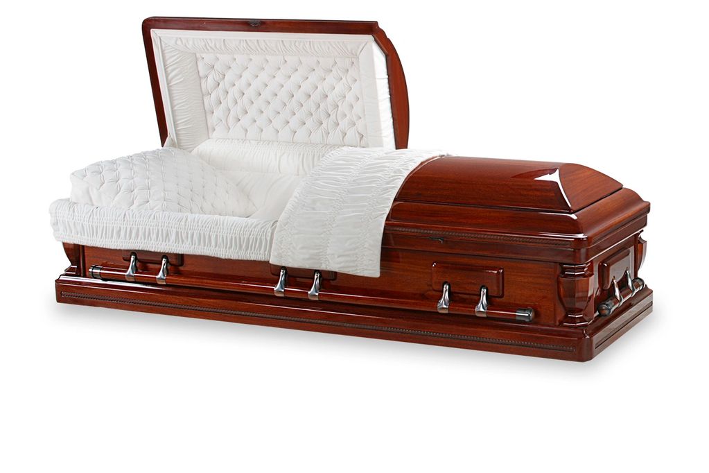 Elegant wooden coffin with white cushioned interior.