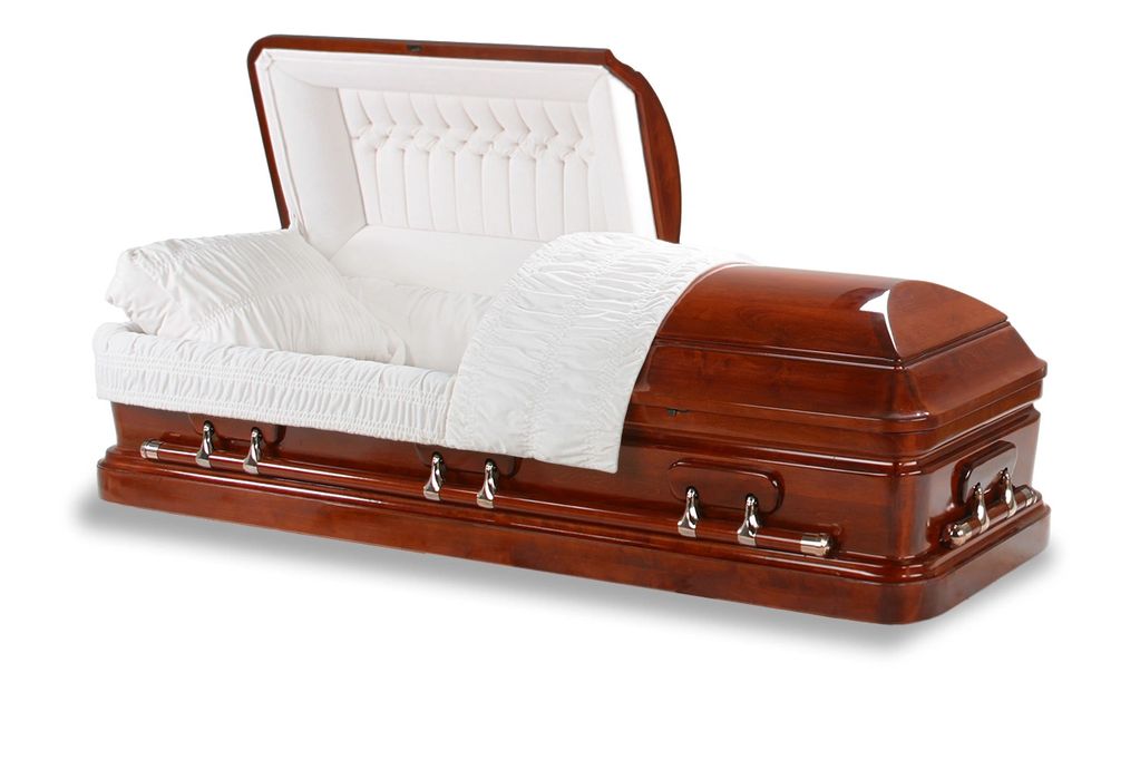 A wooden coffin with white bedding.