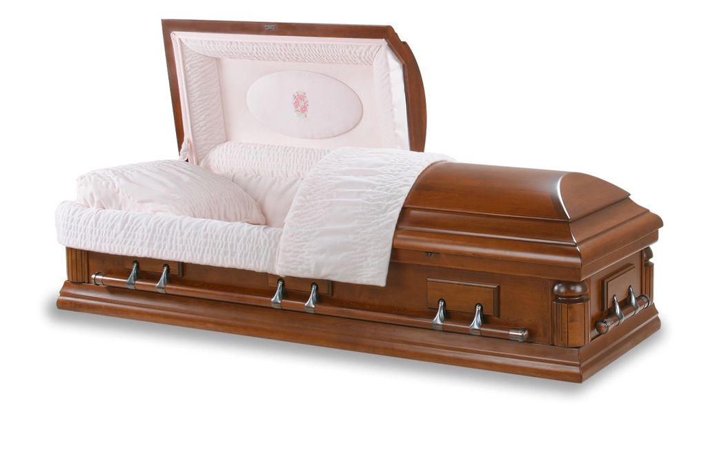 Open wooden casket with pink interior lining.
