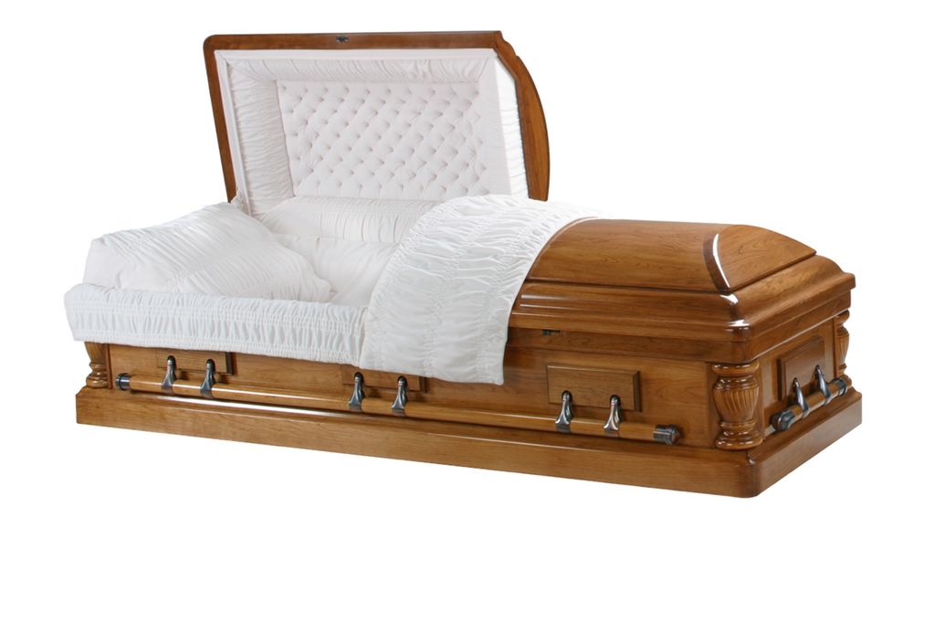 Open wooden coffin with white padded interior.