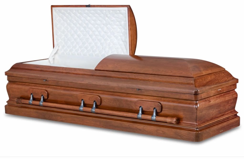 Wooden coffin with open lid showing white interior.
