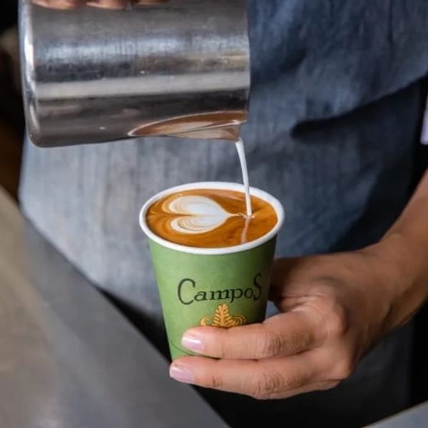 Campos coffee being poured into takeaway cup