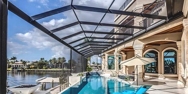 "Luxury pool with screen enclosure repair by Miami Screen Enclosure Repair LLC."