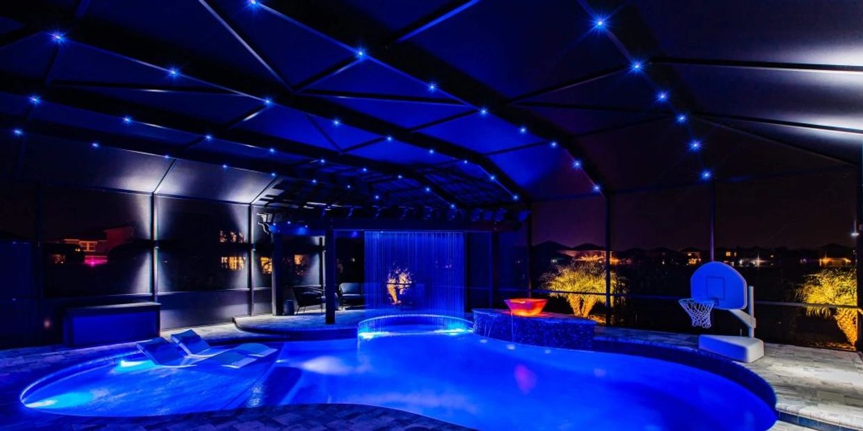 "Night pool with vibrant lighting under a repaired screen enclosure by Miami Screen Enclosure Repair