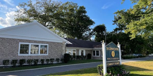Exterior view of a brick building with a sign for The Senior Center.
