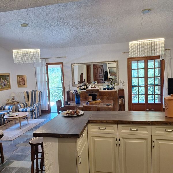 Cozy living and dining area with rustic charm and elegant lighting.
