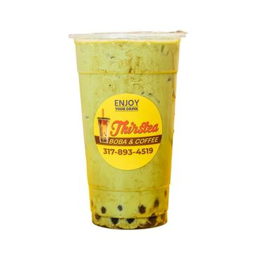 Iced matcha boba drink in a clear plastic cup with a yellow label.