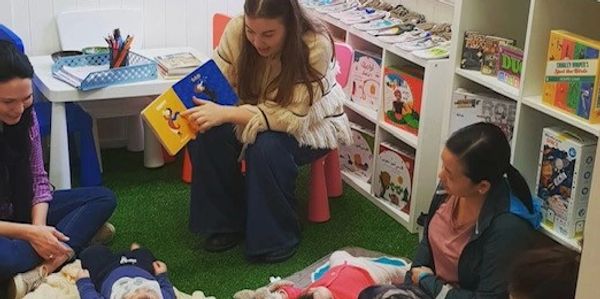 Baby Book Club and Todler Book Club Reading Books for Children in Iwan Bookshop in play ground