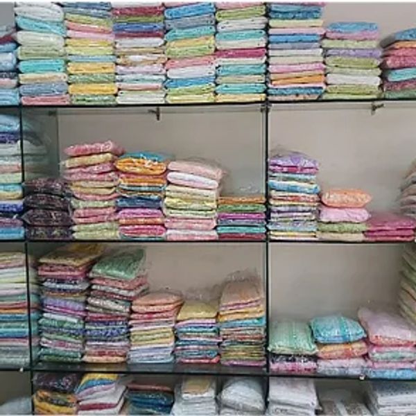 Shelves filled with neatly folded colorful fabrics in various patterns and shades.