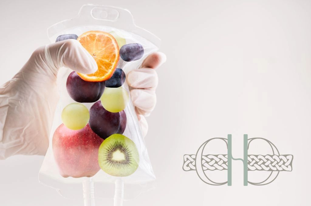 Gloved hand holding an IV bag filled with fruits as nutrition. Celtic Clan Health logo. 