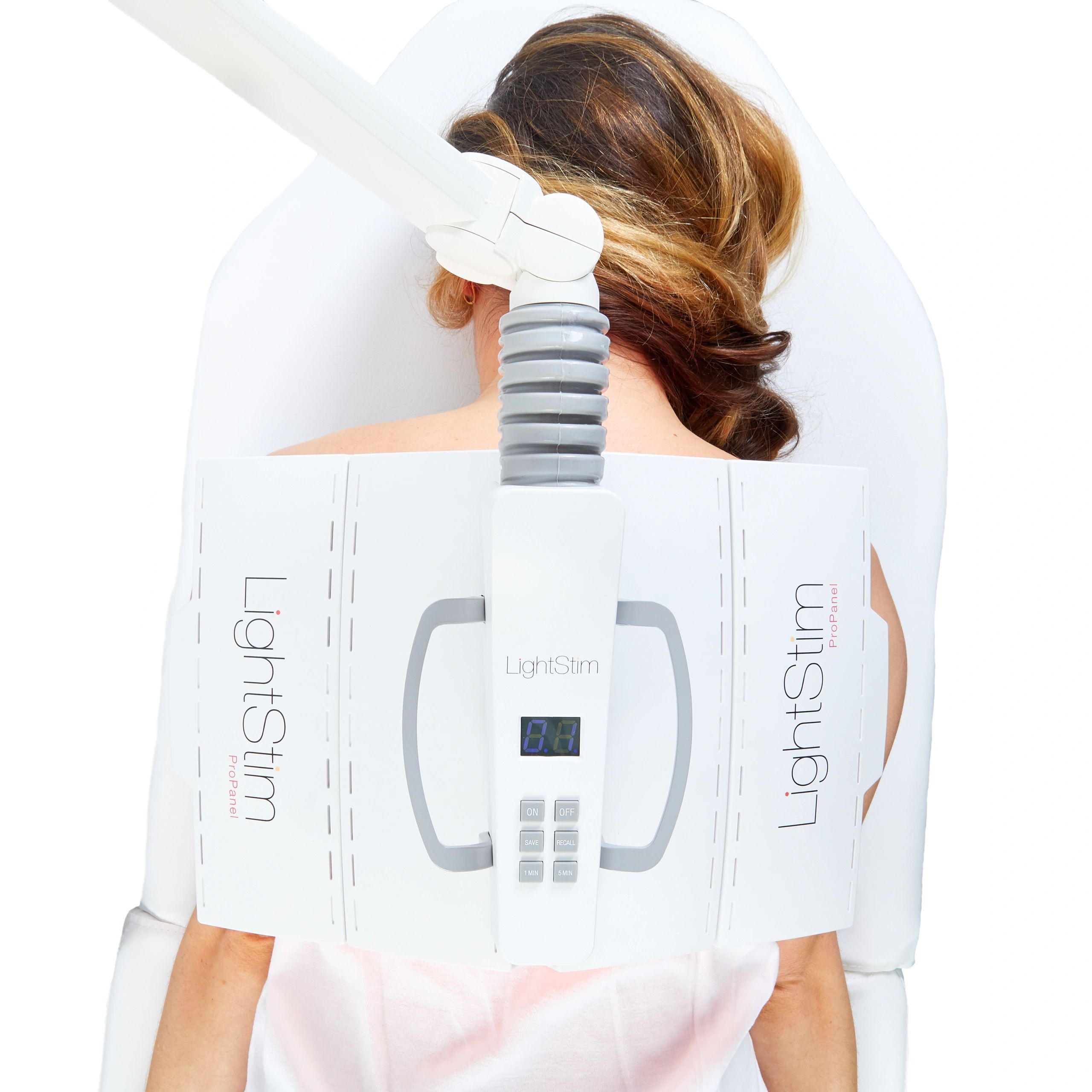 Woman laying face down prone with a LightStim Pro Panel over her back at Celtic Clan Health