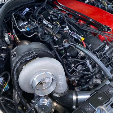 Close-up of a car engine with a Precision Turbocharger installed.