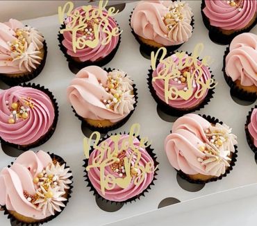 Pink and purple cupcakes decorated for a bridal shower.