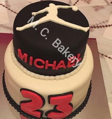 Two-tier cake with Michael Jordan theme and number 23.