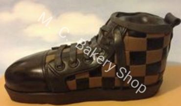 Realistic shoe-shaped cake with brown and black checkered design.