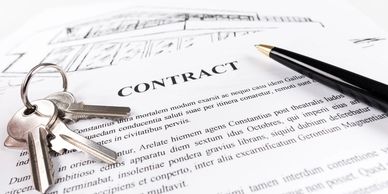 Contract document with keys and a pen on a white background.