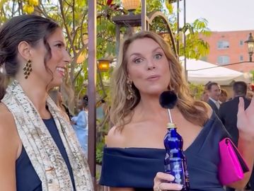 Two women talking at an outdoor event.