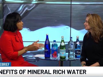 Two women discuss mineral-rich water on a TV show.