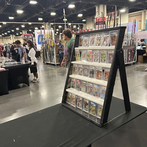 Display stand with graded comic books at a convention.