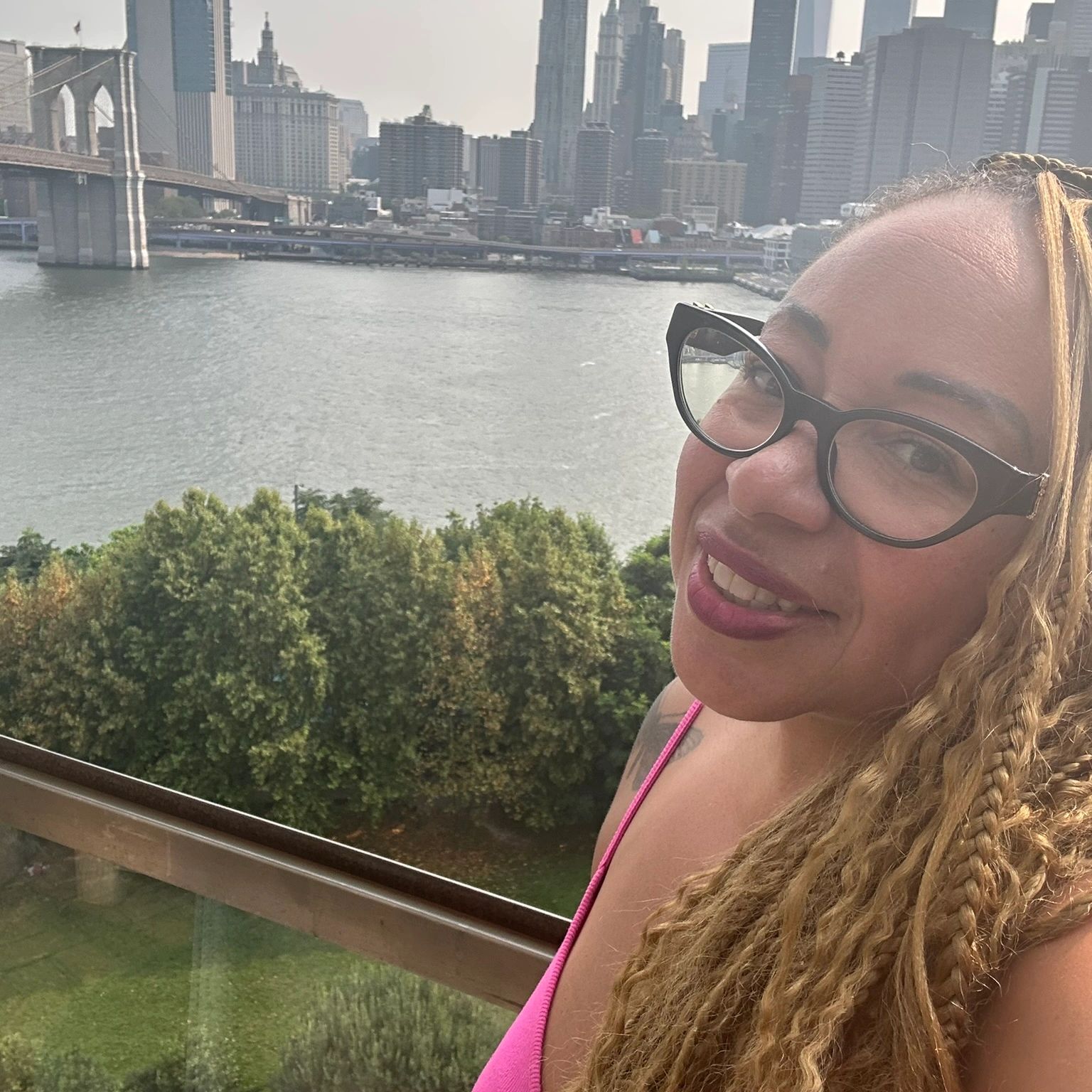 Backdrop of the Brooklyn Bridge and Raven Moore from Raven's Solutions Travel Agency