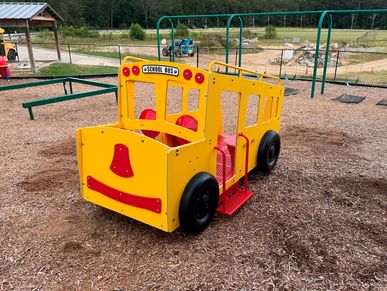 A colorful yellow playground school bus structure for kids.