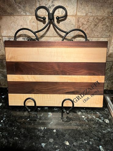 Personalized cutting board made of walnut and maple.