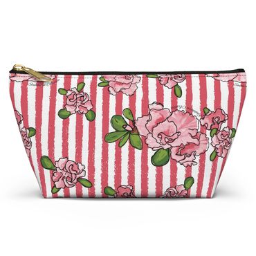 Floral makeup pouch with pink stripes.