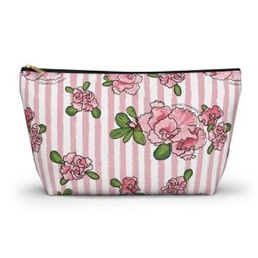 Floral makeup bag with pink stripes.