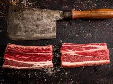 Short Ribs on block with axe. Born & reared in Malpas.