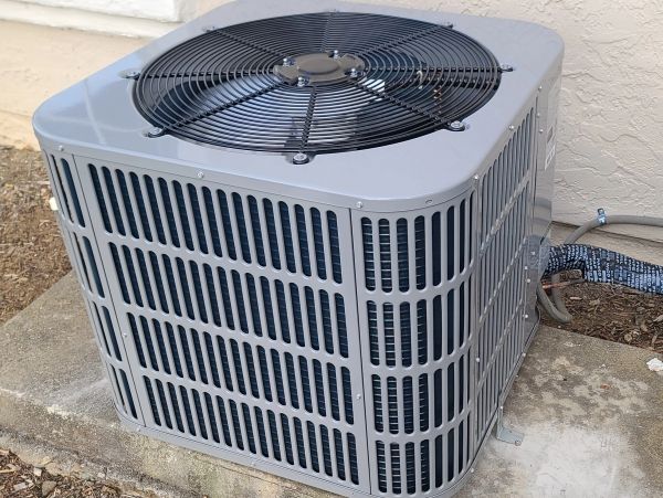 Outdoor air conditioning unit on a concrete slab.