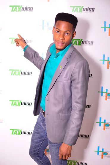 Man pointing at the Taxwise logo on a backdrop.
