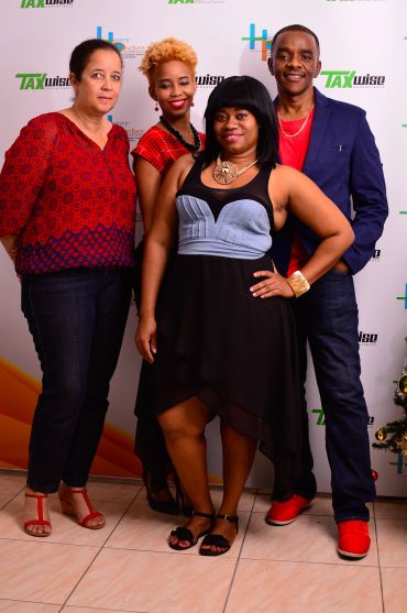 Four people posing together at an event.