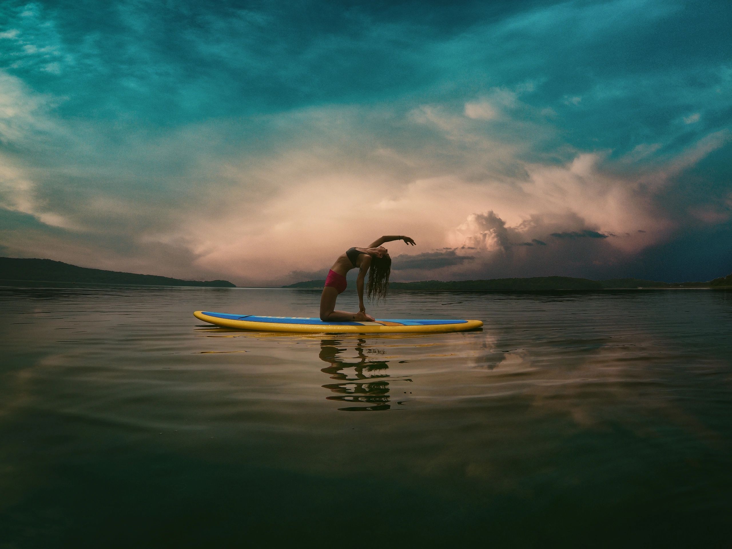 Young Woman Doing Yoga on Sup Board With Paddle.