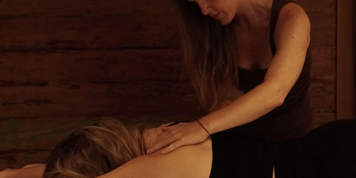 A person giving a shoulder massage.