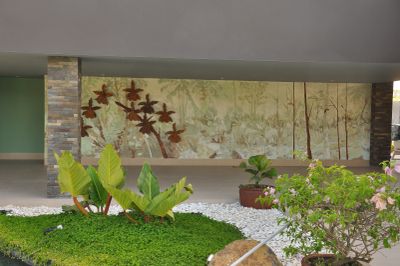 Indoor garden with green plants and wall art.
