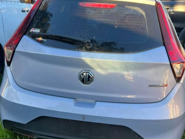 Rear view of a silver MG car with visible MG emblem and model badge.
