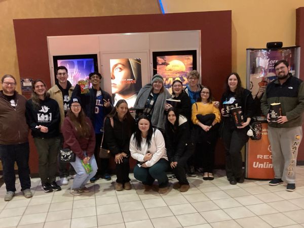 Group of people at a movie theater lobby.