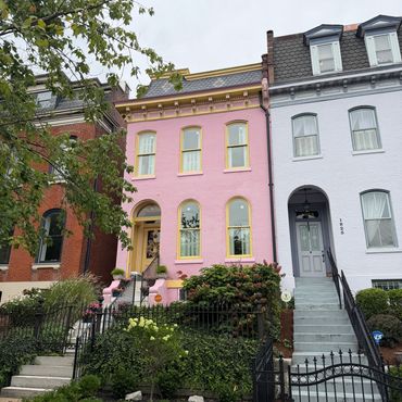 Colorful row houses with pink and gray facades.
