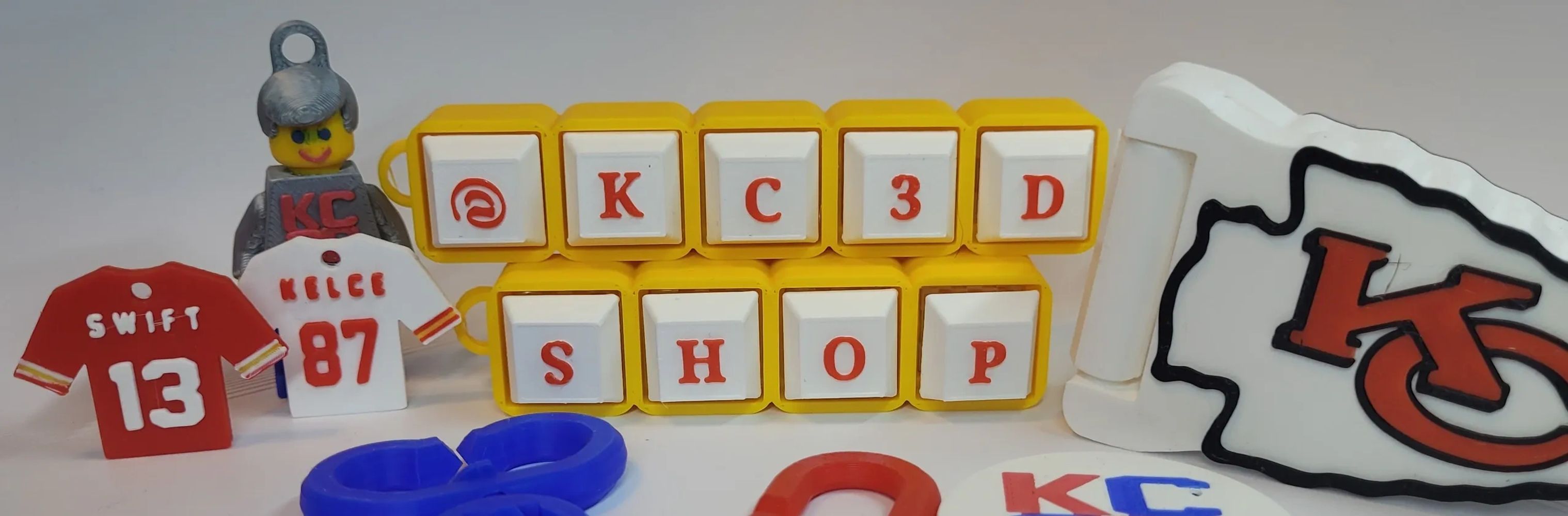 Kansas City Chiefs-themed display with jerseys and logo keychains.